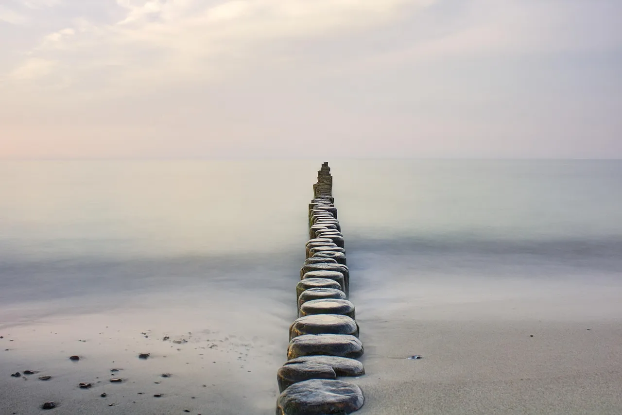 A peaceful groyne stretching into water